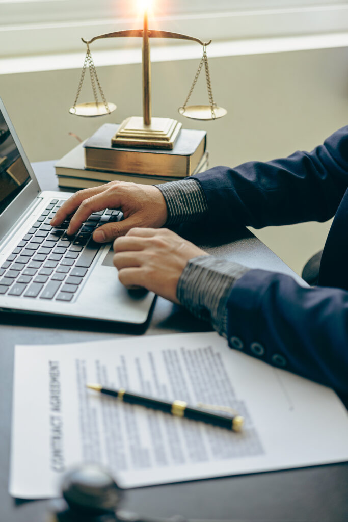 Judge hammer with judge, lawyer, businessman in suit working on legal documents in courtroom, justice and law, lawyer, judge, court concept vertical picture